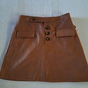 Love & piece flap pocket, salmon-colored mini, with decorative buttons on front.